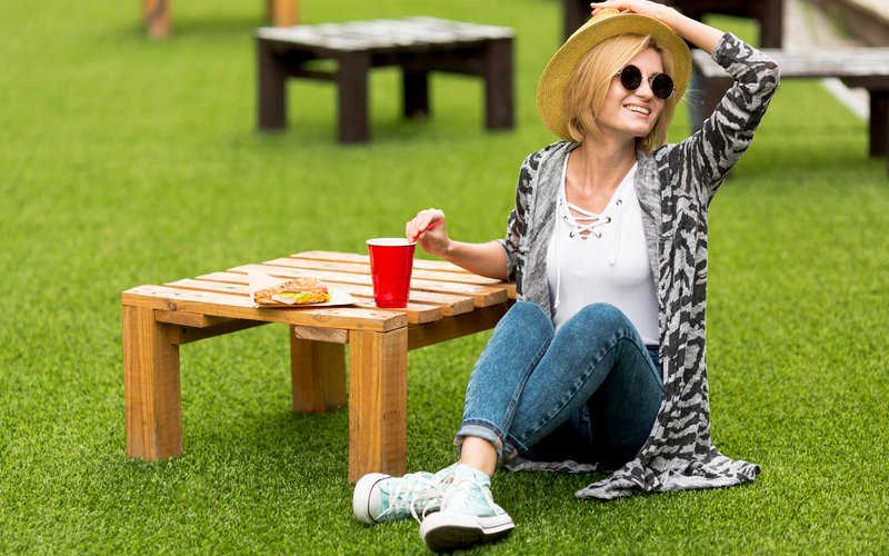 So, your lawn isn’t looking its best. The grass is thin and a bit yellow, like it’s given up on life. But before you blame yourself, take a look up. That magnificent oak tree you’ve been admiring for years? It might be the culprit. Shade is one of the most overlooked reasons British lawns struggle, and most people don’t realise it until the damage is done. The good news is that fixing this problem is far more straightforward than you’d think. Let’s get into it. What Shade Actually Does to Grass Grass needs sunlight to photosynthesise. Without it, its growth slows, its roots weaken, and it ends up losing its colour and density. Every gardener knows that much. But not all shade is equal, and treating it like it is will lead you in the wrong direction from the start. For example, tree shade is dappled and shifts throughout the day as the sun moves. Some light still filters through, which means your grass can survive, but it won’t thrive. Dense, leafy trees are a different story. A thick canopy in full summer can block enough light to make the area beneath it nearly unworkable for sun-loving grasses. And if your home garden is shaded by trees, fences, or nearby buildings, this is a harder problem to fix. This type of shade is consistent, often lasting most of the day. Even tougher varieties, like Kentucky bluegrass, can thin out and lose colour under these conditions. Choose the Right Grass If your lawn is struggling under a tree, throwing down more of the same seed isn’t going to help. Some grasses are naturally better suited to low-light conditions. Fine fescue is the standout choice; it handles shade well, holds a rich green colour, and doesn’t need excessive maintenance to look decent. Shade-tolerant bluegrass varieties are worth considering, too, particularly for areas with partial light. A few things to keep in mind when choosing a species: Check the label. If it doesn’t clearly say ‘shade-tolerant,’ don’t assume it is. Consider your soil type and drainage, as these affect how any grass variety will perform. Mixing shade-tolerant varieties can improve resilience, giving you a lawn that handles variable conditions better. If you’re unsure what will work best for your specific conditions, a chat with a local garden centre or lawn care services professional can save you a lot of trial and error. Let in More Light Sometimes, the problem isn’t the grass itself at all; it’s that your lawn simply isn’t getting enough sunlight to work with. In many cases, a bit of pruning can do more for your grass than switching varieties. Start with the inner canopy. Removing crossing branches and thinning out the crown will allow more dappled light to reach the grass below. You don’t need to reshape the tree completely, though. Even a modest trim can make a noticeable difference. Use clean, sharp tools to avoid damaging the tree in the process. A stressed tree is the last thing you need on top of your worn lawn. Just keep in mind that some spots aren’t suited to grass. If an area is covered in deep shade most of the day, it may make more sense to rethink the layout instead of forcing your lawn to struggle. You could swap those darker patches for shade-tolerant ground covers, low shrubs, or even decorative gravel. Light-coloured stones and pale-painted walls can also help reflect sunlight into darker corners, giving the surrounding grass a bit more light to work with. Aerate and Overseed the Area Once you’ve sorted the light situation as best you can, it’s time to focus on the soil. Grass growing in shade often ends up thinner and weaker, which means the soil underneath gets compacted more easily. With fewer roots moving through it, the ground slowly tightens up. Aeration, poking holes roughly 5–8 cm deep across your lawn, allows air, water, and nutrients to reach the roots. This is especially important if your lawn is shaded, because compaction compounds the light problem. Roots that can’t breathe don’t grow well, full stop. The best times to aerate in the UK are early spring or early autumn, when the grass is actively growing and can recover quickly. After aerating, overseeding can help thicken up your lawn and fill in any bare patches. For the best results, use a spreader to ensure even coverage and choose seed labelled for shade. So, when should you overseed? Autumn offers an ideal window, since the cooler temperatures and more frequent rain give seeds a chance to establish before winter sets in. Avoid Overfeeding and Overwatering Shaded lawns don’t behave like their sunny counterparts, and your feeding and watering routine needs to reflect that. Fertilisation High-nitrogen feeds can push lush top growth that the shade then struggles to support, which causes more problems than it solves. So, a balanced, slow-release fertiliser, around a 15-5-10 NPK ratio, works best here. Fertilise in early spring (March to mid-April) and again in late summer (late August to early September). Also, don’t forget to watch the colour—a healthy deep green means you’ve got it right. Watering Shaded areas dry out more slowly, so watering them less frequently is usually fine. Once or twice a week is plenty. When you do water your lawn, make sure it soaks in 5–8 cm deep instead of sitting on the surface. In any case, avoid over-watering. Damp, shaded soil offers the ideal conditions for moss, pests, and fungal issues, neither of which you want to encourage. Maintain Your Lawn Long-Term Shaded lawns require slightly different maintenance techniques to stay healthy through the seasons. First off, mow a little higher than you normally would, around 8–9 cm. Longer blades mean more surface area for photosynthesis, which is crucial when light is already limited. While you’re at it, check the soil’s pH levels periodically, as shaded, damp areas can become more acidic over time. Keep an eye out for weeds, too. They’re opportunists and will move into thin patches faster than your grass can recover. Conclusion Shade doesn’t have to mean a patchy, sorry-looking lawn. It just means approaching things a bit differently. Luckily, you now know more about shaded lawn care than most people ever will. So, go give that neglected patch the attention it deserves.